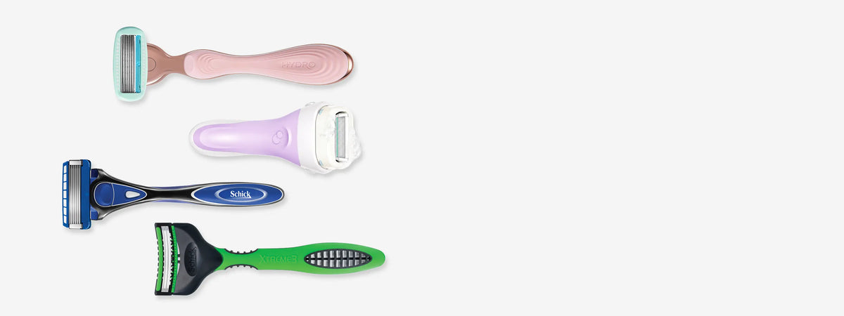 Four different colored razors on a white background